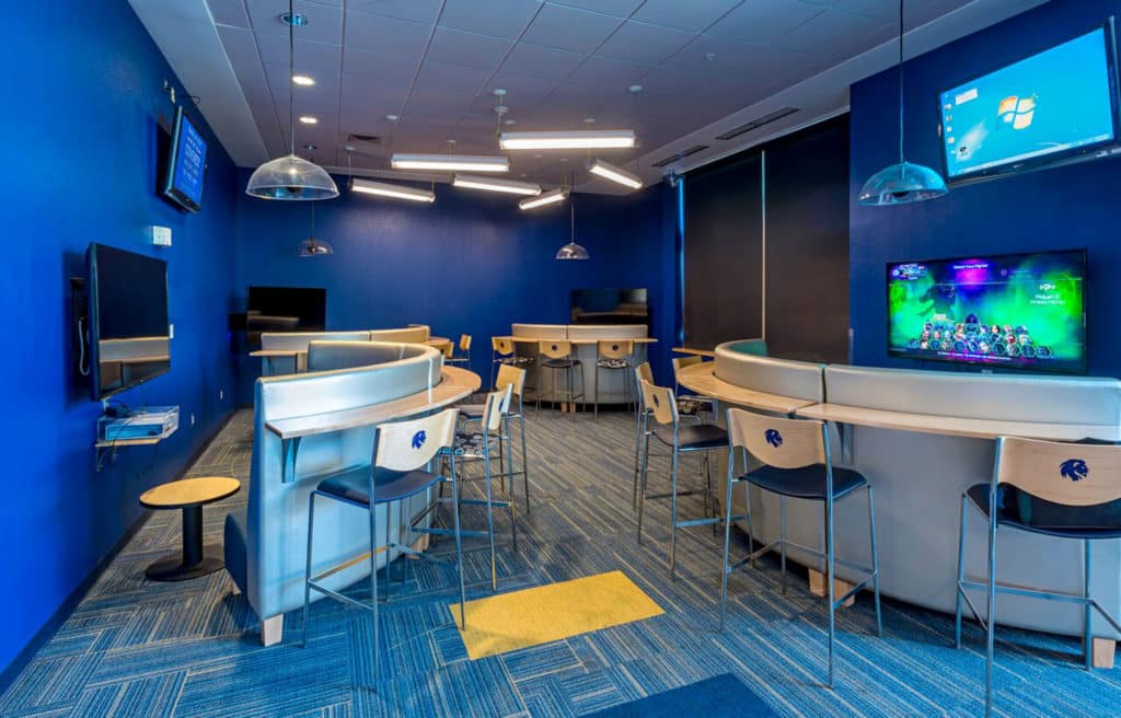 Texas A&M University Commerce commercial renovation of student area with gaming consoles each with several barstools along a curved bar area